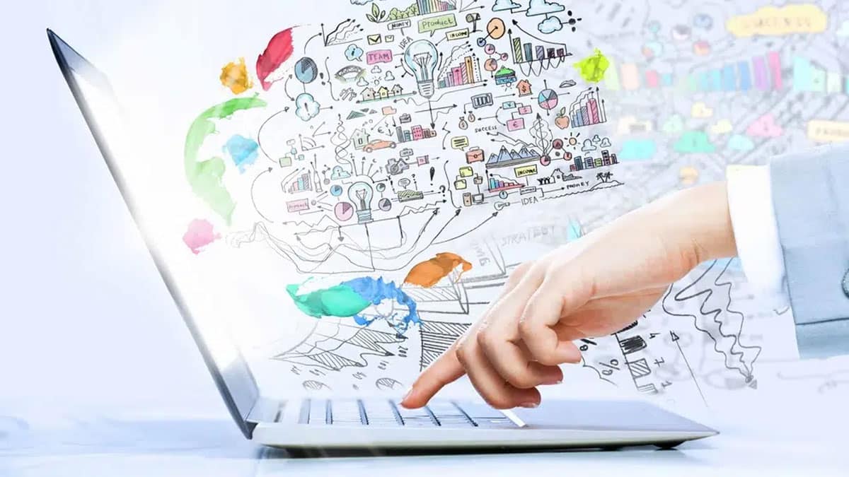 Laptop with a finger on a keye with wireframe drawings in the background