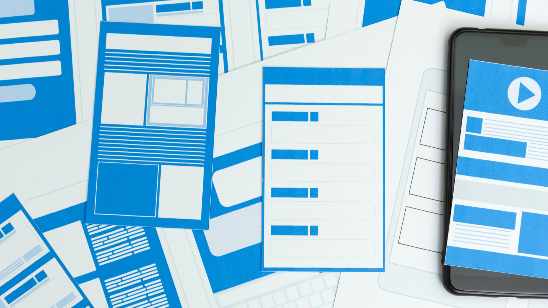 Various wireframes displayed on paper