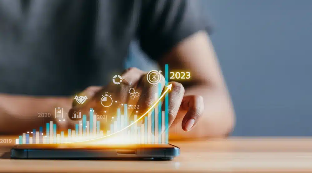Person interacting with a smartphone displaying a futuristic financial growth chart.